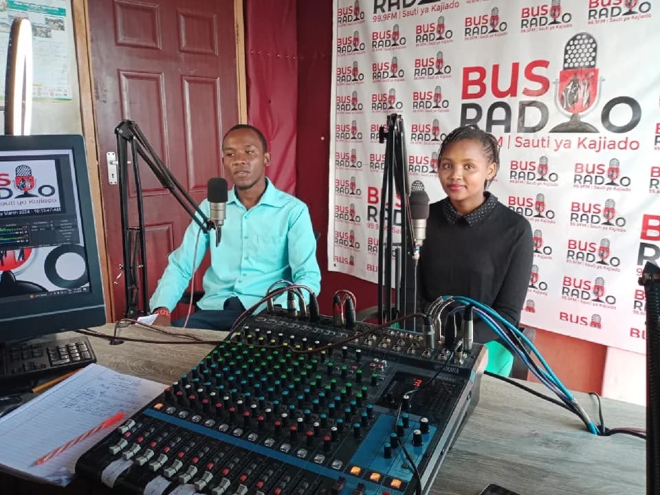Young participants in discussion at the Bus Radio studio